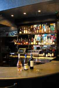 Bar with wine bottles and glass on counter